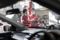 Car mechanics at work in repair garage — Stock Photo