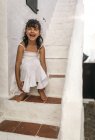 Ritratto di bambina ridente seduta su un gradino — Foto stock
