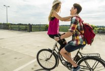 Happy young couple together on a bicycle — Stock Photo