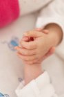 Закри новонароджених близнюків спальний рука об руку — стокове фото