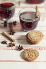Home-baked almond biscuits with glasses of mulled wine and spices — Stock Photo