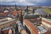 Germany, Dresden, Cityscape with tower of Dresden Castle, Hausmann Tower and Cathedral by Elbe river — Stock Photo
