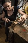 Luthier manufacturing a guitar in her workshop — Stock Photo