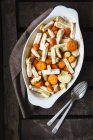 Roasted carrot, parsnip and celeriac on casserole dish — Stock Photo