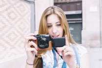 Spain, Barcelona, young woman taking a picture with digital camera — Stock Photo