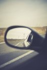 Germany, Brandenburg, reflection of wind turbines in wing mirror on a country road — Stock Photo