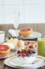 Breakfast, laid table, fresh fruit muesli — Stock Photo