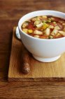 Closeup of bowl with minestrone soup on table — Stock Photo