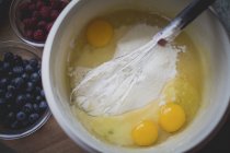 Preparing dough in white bowl — Stock Photo