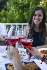 Friends toasting with lambrusco wine during a summer dinner — Stock Photo