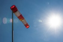 Close-up of Windsock against sun and blue sky — Stock Photo