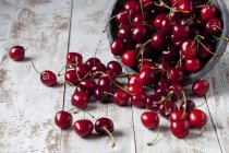 Ciliegie fresche con ciotola rovesciata — Foto stock