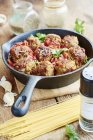 Vegan meatless balls in tomato sauce in a cast iron pan — Stock Photo