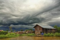 Myanmar, settlement at Lake Inle and old barn under clouds — Stock Photo