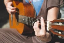 Close up of Woman playing guitar — Stock Photo
