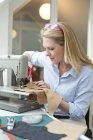 Woman with sewing machine — Stock Photo