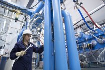 Technician with screw wrench in factory hall — Stock Photo