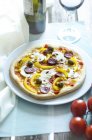 Homemade pizza with mushrooms, yellow peppers, tomatoes, green olives, chorizo on plate — Stock Photo