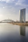 Germany, Hesse, Frankfurt, ECB Tower at Main river in evening haze — Stock Photo