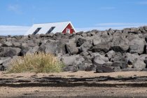 Islanda, Stokkseyri, casa nascosta dietro un muro di pietra — Foto stock