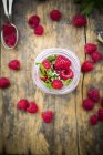Raspberries, chia, milk, kiwi, hemp seed and mint in a glass — Stock Photo