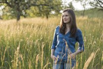 Young woman in a field in the evening — Stock Photo