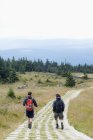 Germany, Harz, Brocken, two friends hiking in mountains — Stock Photo