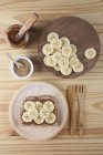 Тост з Дульче де Лече, бананові шматочки і Кунжутного насіння на дерев'яні пластини і таблиці — Stock Photo