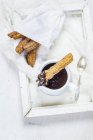 Fried Churros with hot chocolate on white wooden tray — Stock Photo