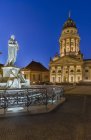 Germany, Berlin, lighted French Cathedral and statue of Friedrich Schiller at Gendarmenmarkt — Stock Photo