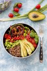 Fried chicken, quinoa, tomatoes, avocado, spring onion, rosemary and basil in bowl — Stock Photo