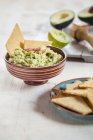 Guacamole and home-made crackers — Stock Photo