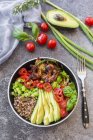 Fried chicken, quinoa, tomato, avocado, spring onion, rosemary and basil in bowl — Stock Photo