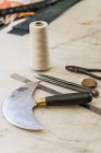 Closeup view of tools on working surface in saddlery — Stock Photo
