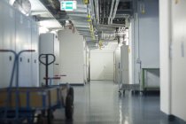 Interior view of cellar with utility engineering and transporting carts — Stock Photo