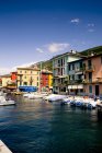 Italy, Veneto, Brenzone, Lake Garda, Castelletto di Brenzone, Harbour with boats over water — Stock Photo