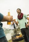 Group of friends drinking beer and having a barbecue — Stock Photo
