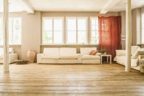 Spacious living room with wooden floor — Stock Photo