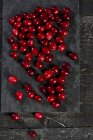 Fresh red Cranberries on slate — Stock Photo