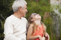 Grand-père et heureuse petite-fille avec des lunettes de soleil à l'extérieur — Photo de stock