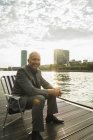 Germany, Frankfurt, relaxed businessman at river Main — Stock Photo