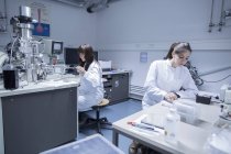 Two female technicans working in a technical laboratory — Stock Photo