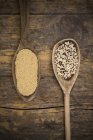 Wooden spoons of organic amaranth and quinoa grains — Stock Photo