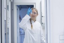 Young female scientist working in a pharmacy research laboratory — Stock Photo