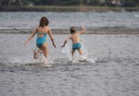 Niños jugando feliz en el lago en la naturaleza - foto de stock