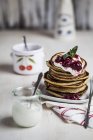 American pancakes with cherry sauce and greek yogurt — Stock Photo