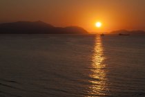 Spain, Bilbao, Coast, Sunset over calm water — Stock Photo