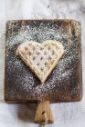 Heart-shaped waffle on cutting board — Stock Photo