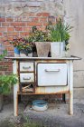 Germany, Bavaria, Old oven with flower pots during daytime — Stock Photo