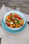 Vegan salad with spelt wheat, sesame, tofu, red bell pepper, snow peas and carrots served in clay bowl — Stock Photo
